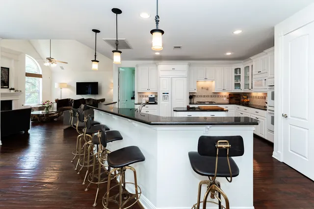 a kitchen with counter top space appliances and wooden floor
