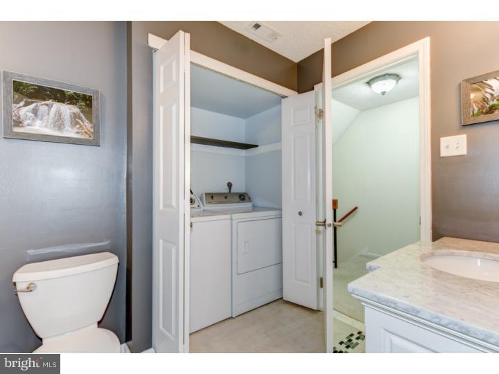 306 Paddock Drive Chesterbrook, PA 19087 - Photo 14 of 16 a bathroom with a toilet sink and mirror
