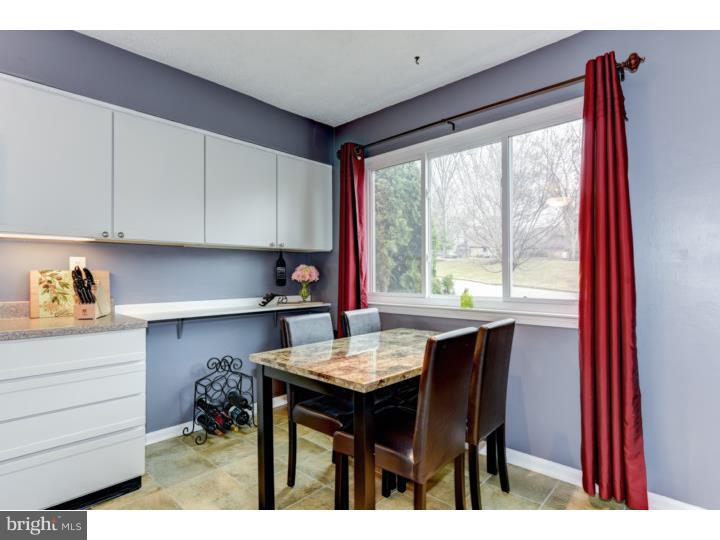 306 Paddock Drive Chesterbrook, PA 19087 - Photo 7 of 16 a kitchen with a table chairs and cabinets