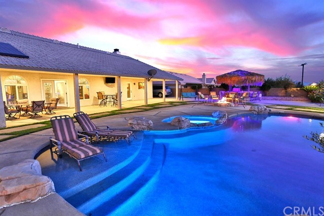 13306 Choco Road Apple Valley, CA 92308 - Photo 1 of 1 a view of a swimming pool with seating area