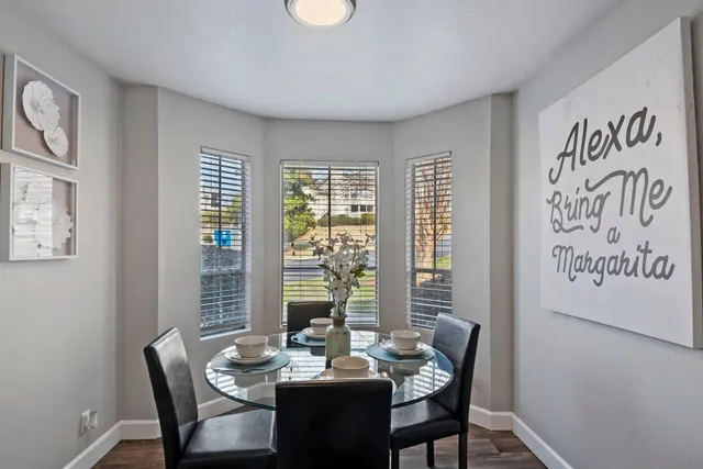 a dining room with furniture and window