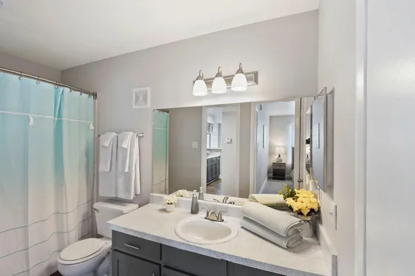 a bathroom with a sink toilet and shower