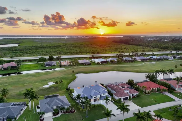 an aerial view of a houses with outdoor space lake view and mountain view in back