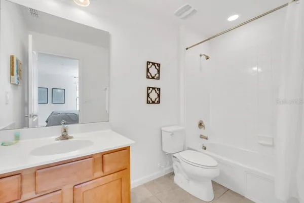 a bathroom with a sink toilet vanity and shower