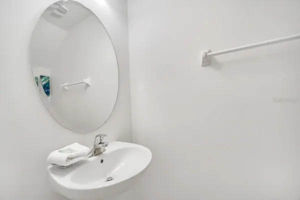 a bathroom with a sink and mirror