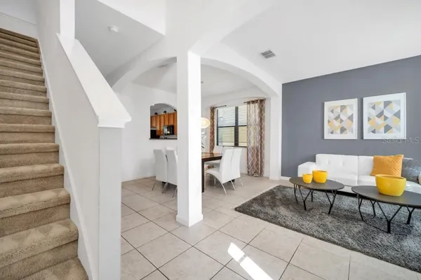 a living room with furniture and wooden floor