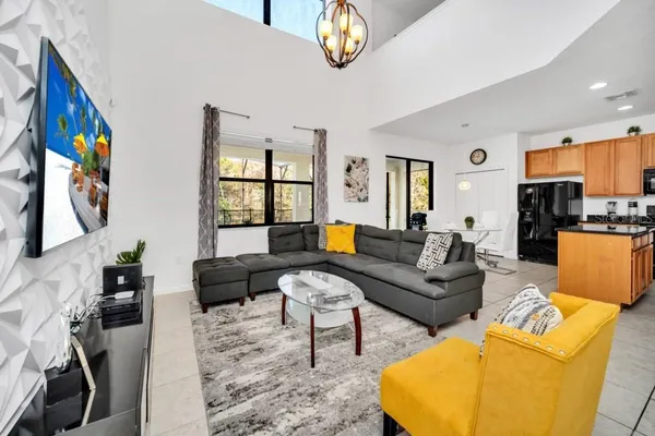a living room with furniture a couch and chandelier