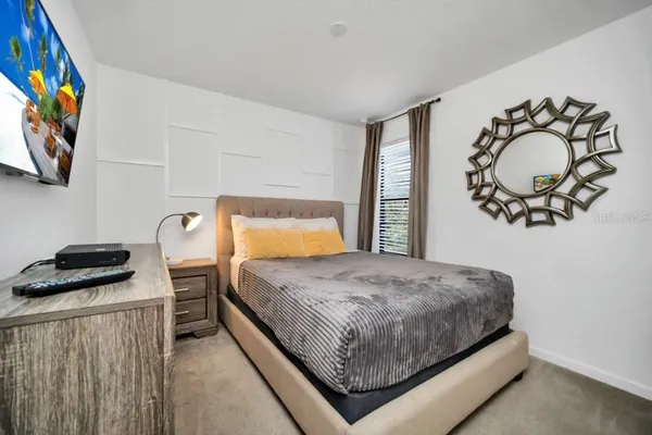 a bedroom with a bed and window