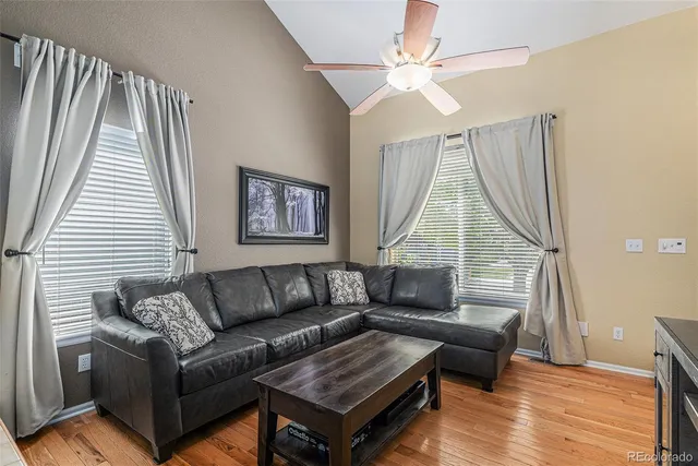 a living room with furniture and a wooden floor