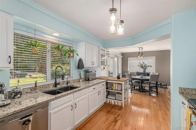 a kitchen with lots of counter space a sink and windows