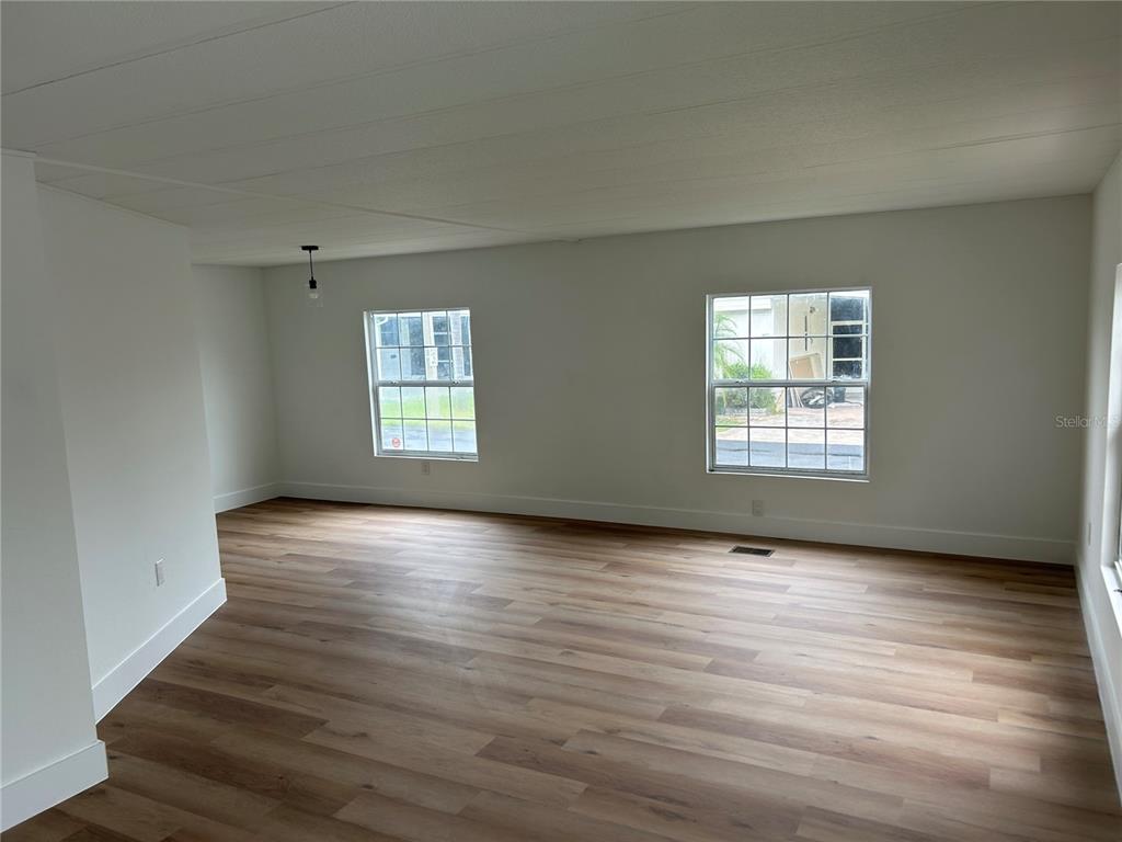 4443 Tucker Square New Port Richey, FL 34652 - Photo 12 of 24 an empty room with wooden floor and windows