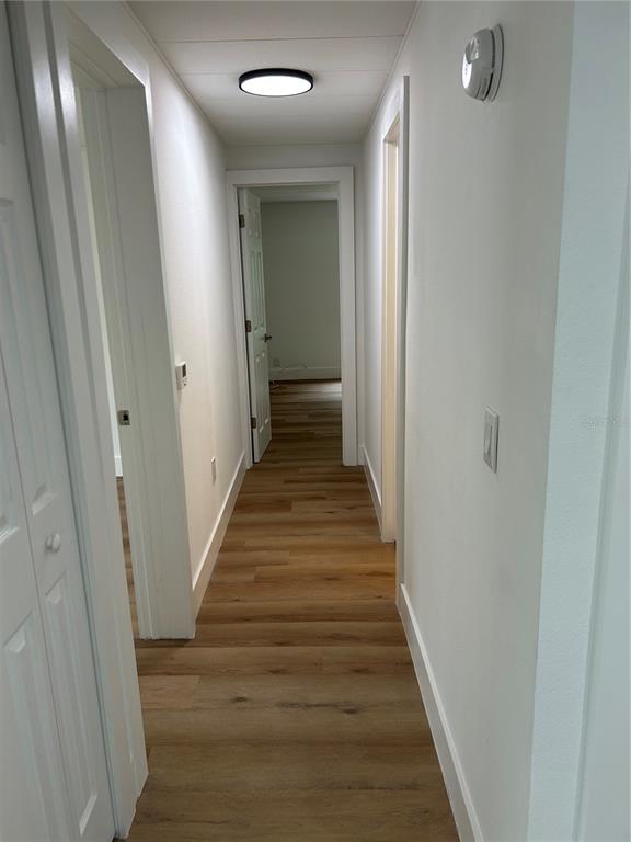 4443 Tucker Square New Port Richey, FL 34652 - Photo 16 of 24 a view of a hallway with wooden floor