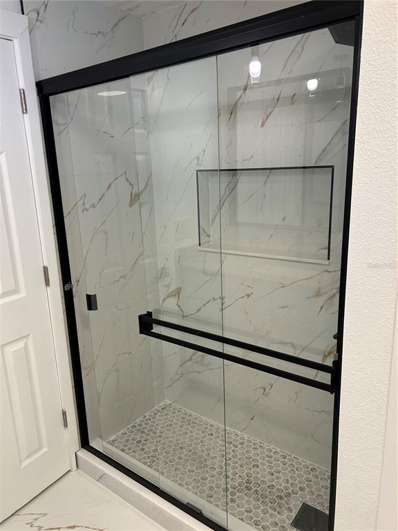 4443 Tucker Square New Port Richey, FL 34652 - Photo 19 of 24 a bathroom with a glass shower door