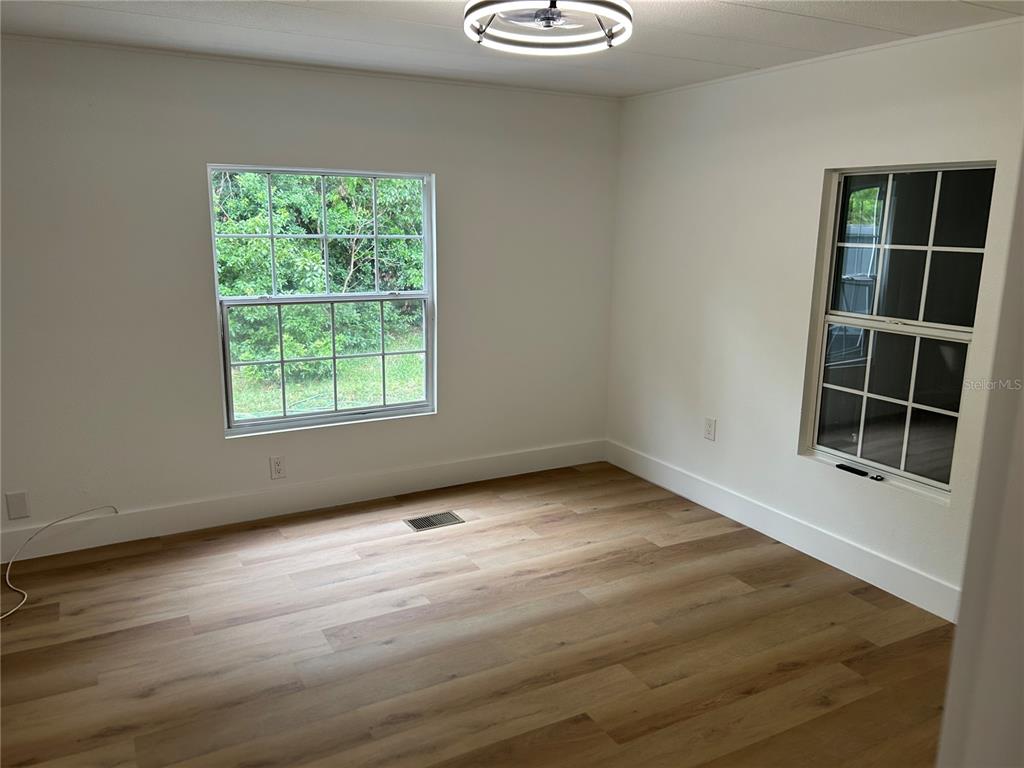 4443 Tucker Square New Port Richey, FL 34652 - Photo 20 of 24 an empty room with wooden floor and windows