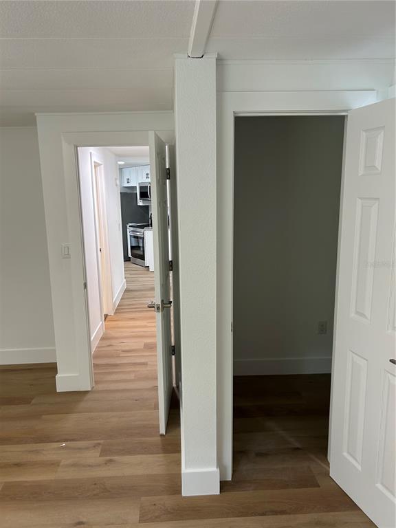 4443 Tucker Square New Port Richey, FL 34652 - Photo 22 of 24 a view of a hallway with wooden floor and staircase