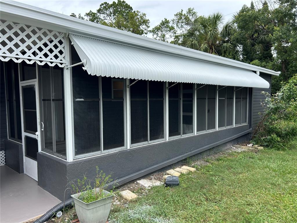 4443 Tucker Square New Port Richey, FL 34652 - Photo 7 of 24 a view of a house with a small yard and wooden fence