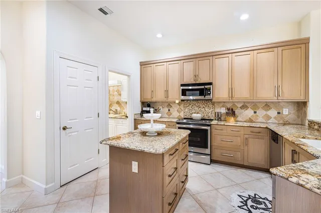 a kitchen with a sink stove and microwave