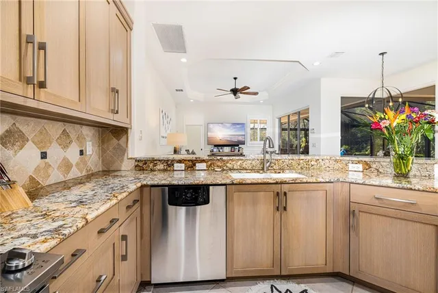 a kitchen with kitchen island granite countertop white cabinets and white appliances