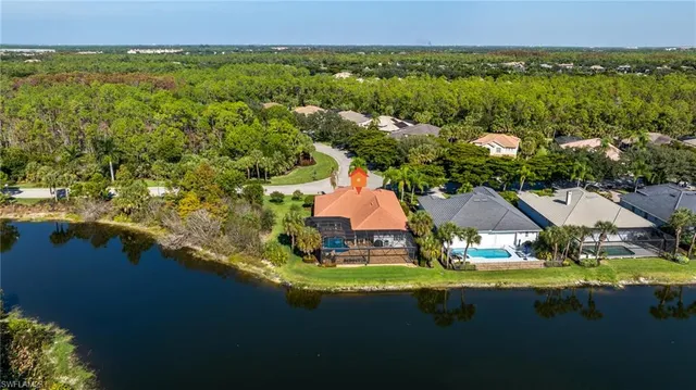 an aerial view of residential houses with outdoor space and swimming pool