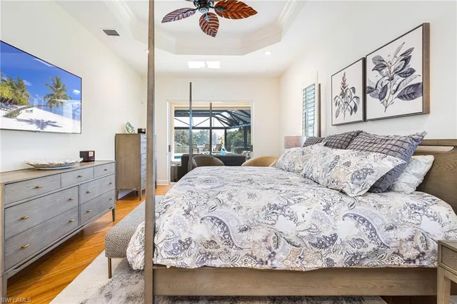 a bedroom with a bed and dresser with mirror