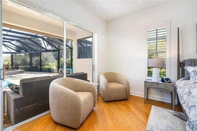 a living room with furniture a large window and a rug