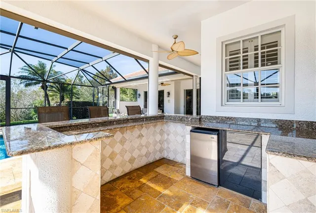 a view of living room with granite countertop furniture and floor to ceiling window