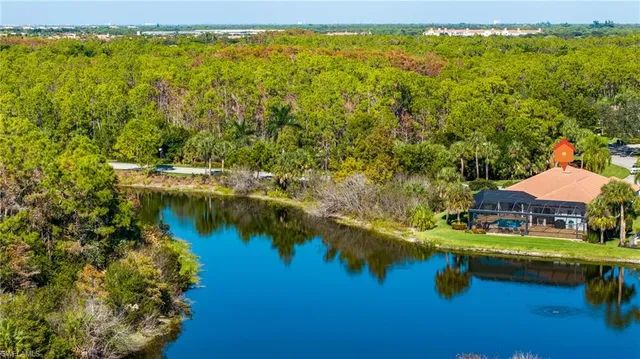 a view of a lake with lawn chairs