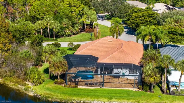a view of a backyard with table and chairs and potted plants