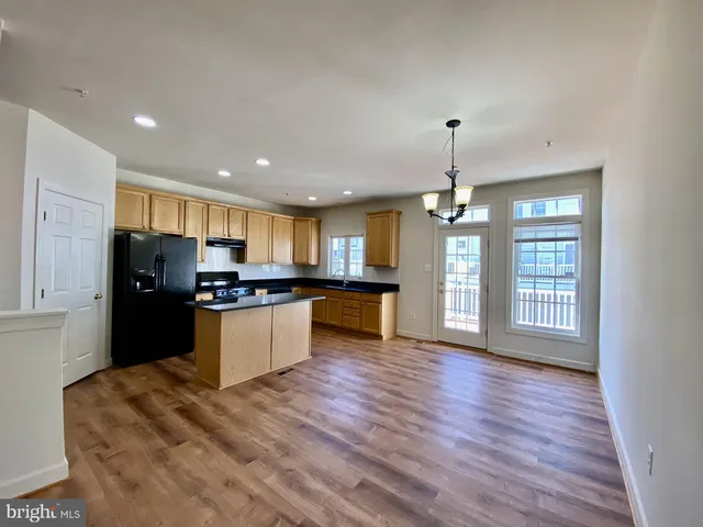 a kitchen with a refrigerator and a sink
