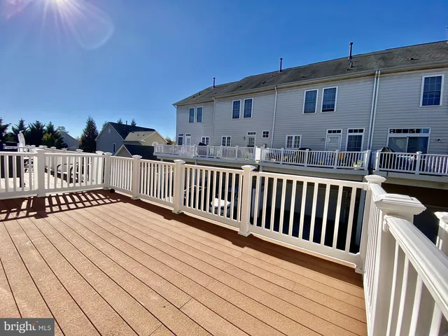 a view of a house with wooden deck