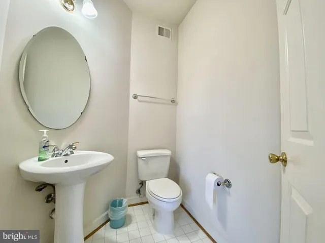 a bathroom with a sink toilet and a mirror