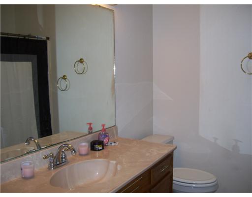 4414 Aspen Grove Drive Corpus Christi, TX 78413 - Photo 6 of 8 a bathroom with a granite countertop sink and a mirror