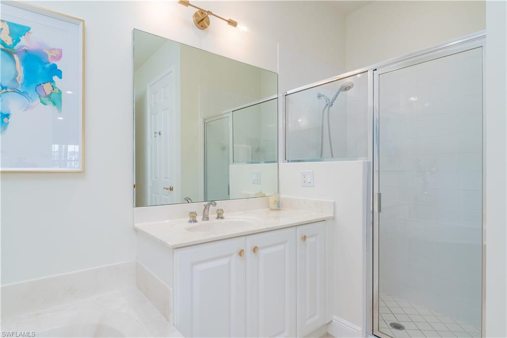 9271 Museo Circle, Unit 102 Naples, FL 34114 - Photo 12 of 35 a bathroom with a sink mirror and a shower