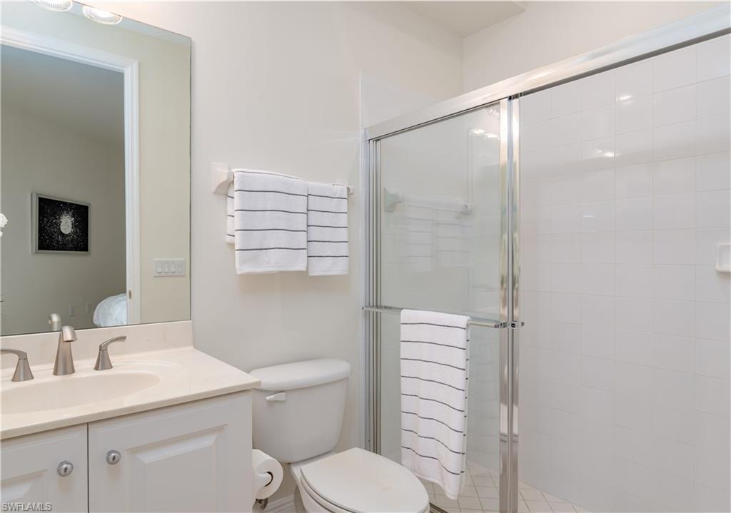 9271 Museo Circle, Unit 102 Naples, FL 34114 - Photo 15 of 35 a bathroom with a sink a toilet and shower
