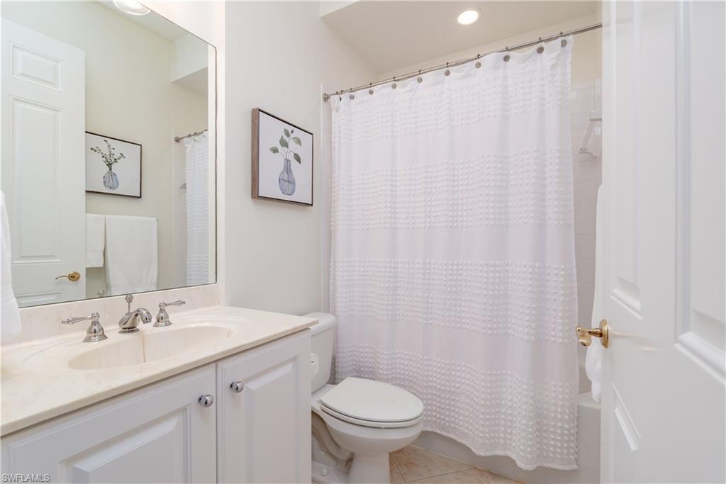 9271 Museo Circle, Unit 102 Naples, FL 34114 - Photo 17 of 35 a bathroom with a sink toilet and a mirror
