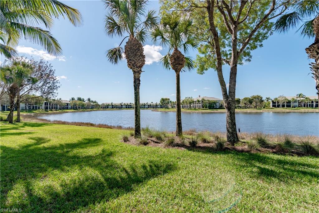 9271 Museo Circle, Unit 102 Naples, FL 34114 - Photo 21 of 35 a view of a lake with a big yard and palm trees