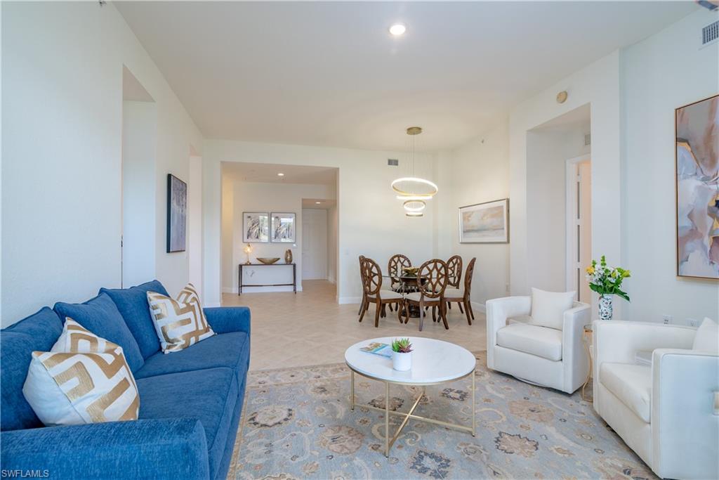 9271 Museo Circle, Unit 102 Naples, FL 34114 - Photo 24 of 35 a living room with furniture and wooden floor