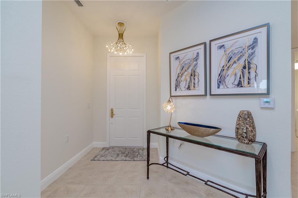 9271 Museo Circle, Unit 102 Naples, FL 34114 - Photo 3 of 35 a view of entryway with paintings on the wall