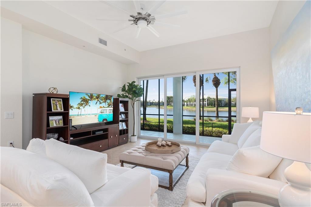9271 Museo Circle, Unit 102 Naples, FL 34114 - Photo 5 of 35 a living room with furniture and a flat screen tv