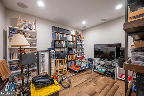 a view of a room with gym equipment and a flat screen tv