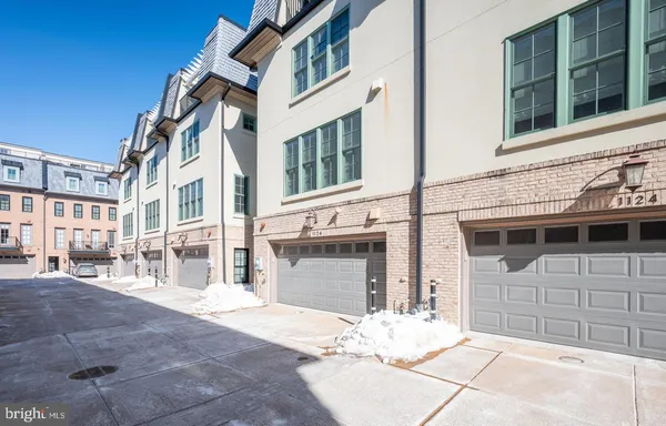 a view of a brick house with many windows