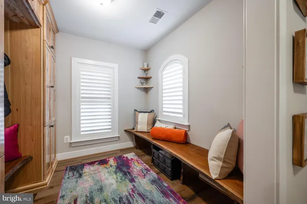 a view of a hallway with entryway wooden floor and front door