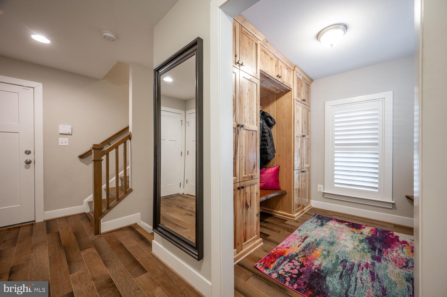 1126 North Stuart Street Arlington, VA 22201 - Photo 24 of 38 a view of a hallway with entryway wooden floor and front door