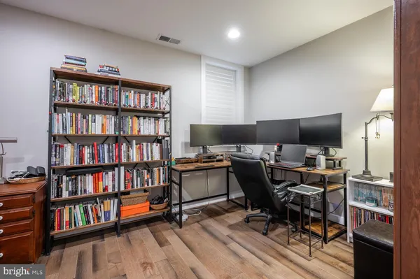 a view of a hallway with wooden floor and staircase
