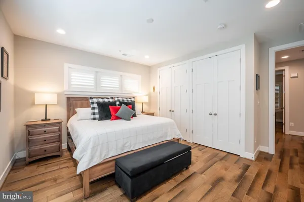 a bedroom with a bed and a night stand