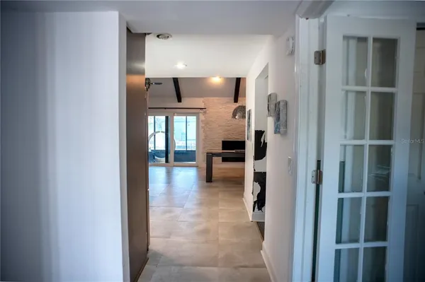 a view of hallway with livingroom and stairs