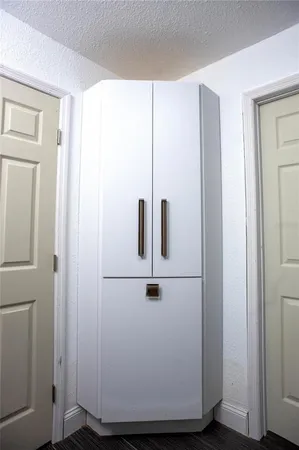 a white cabinet sitting in a bathroom