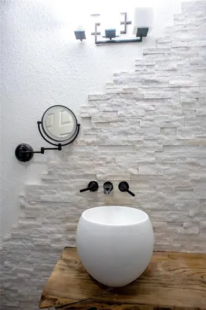 a bathroom with a sink and mirror