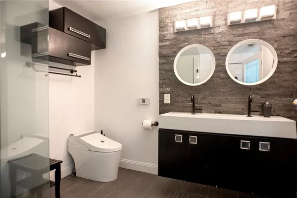 a bathroom with a toilet a sink and a mirror