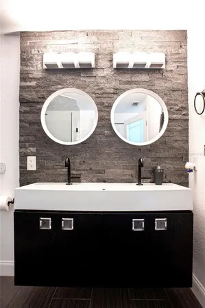 a bathroom with a sink granite counter and a mirror